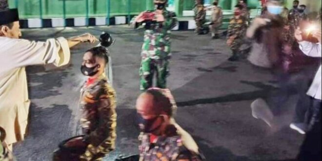 Habib Luthfi menyiram air anggota Banser setelah mengikuti pelatihan NU Online
